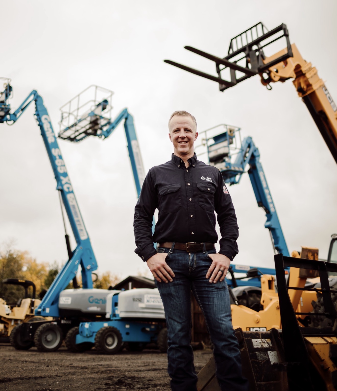 Andrew Heesacker in front of Arvada Rent-Alls equipment